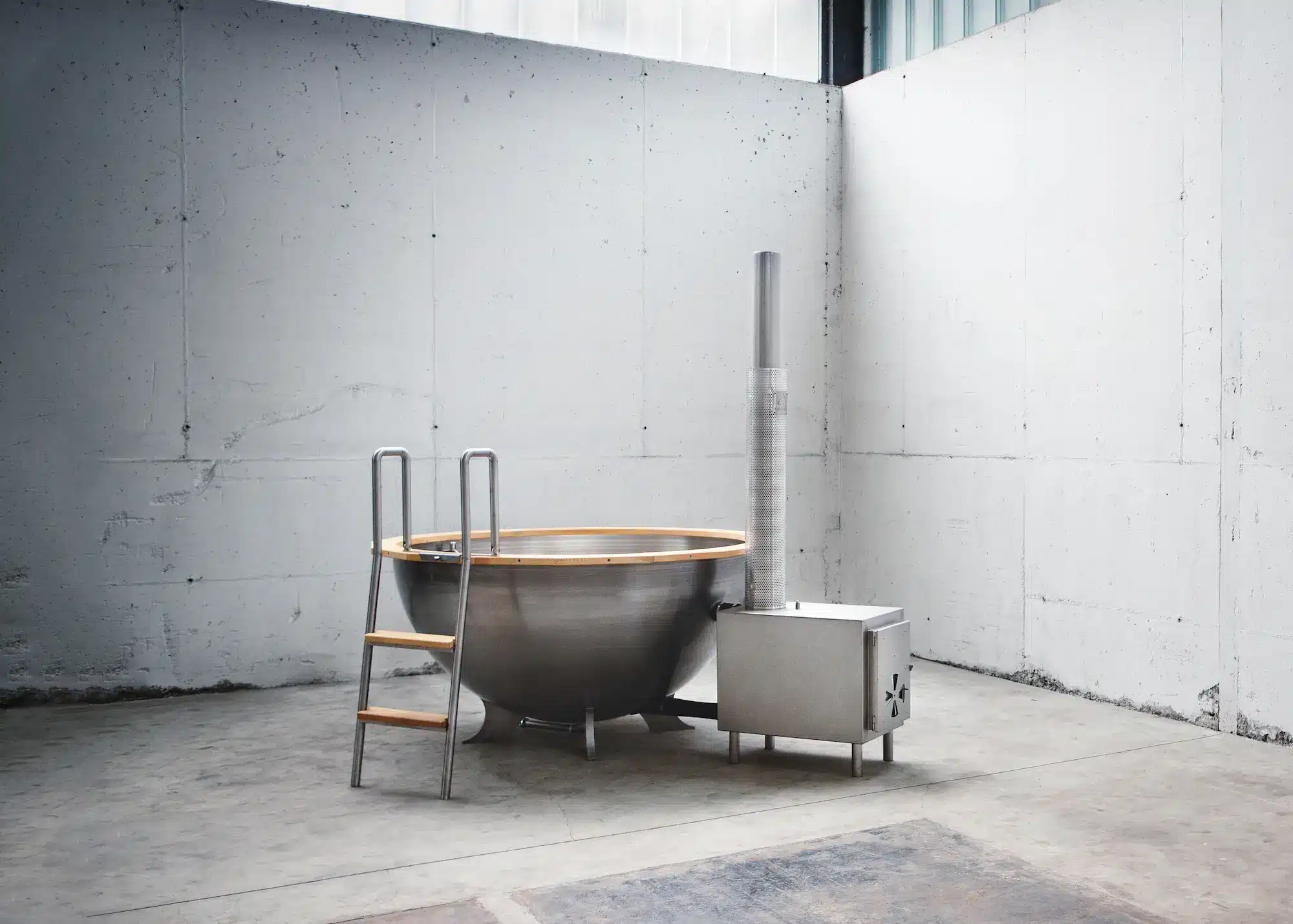 Badezuber aus Edelstahl mit Holzofen in einer Werkstatt von Feuerwasser