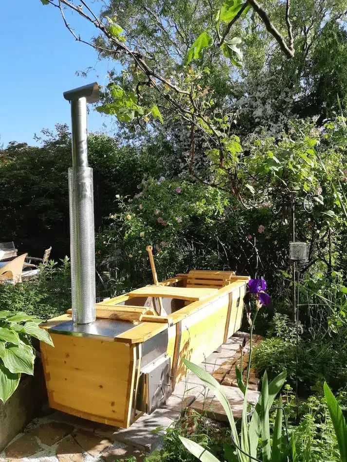 Outdoor-Badewanne von Feuerwasser im Frühling in grünem Garten